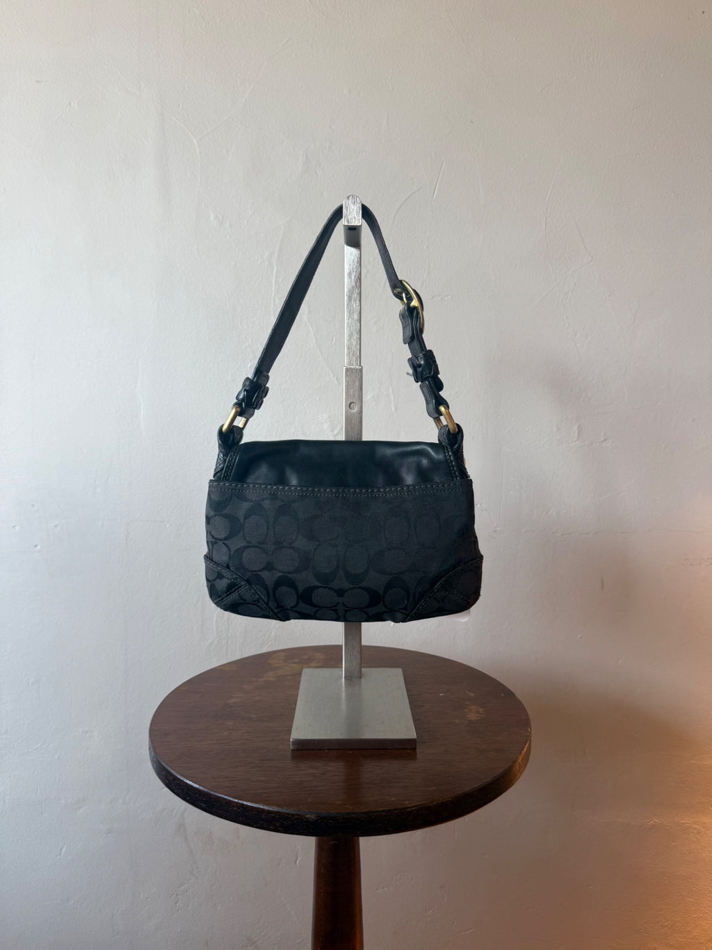 black with gold hardware coach monogram flap hobo